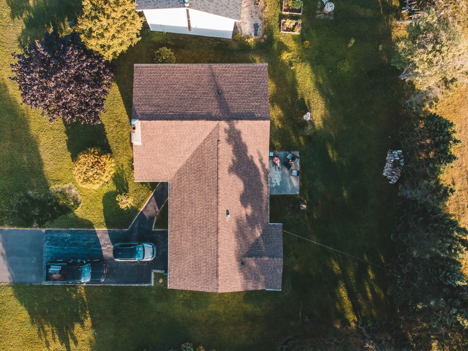 A roofing professional replacing asphalt shingles on a residential roof