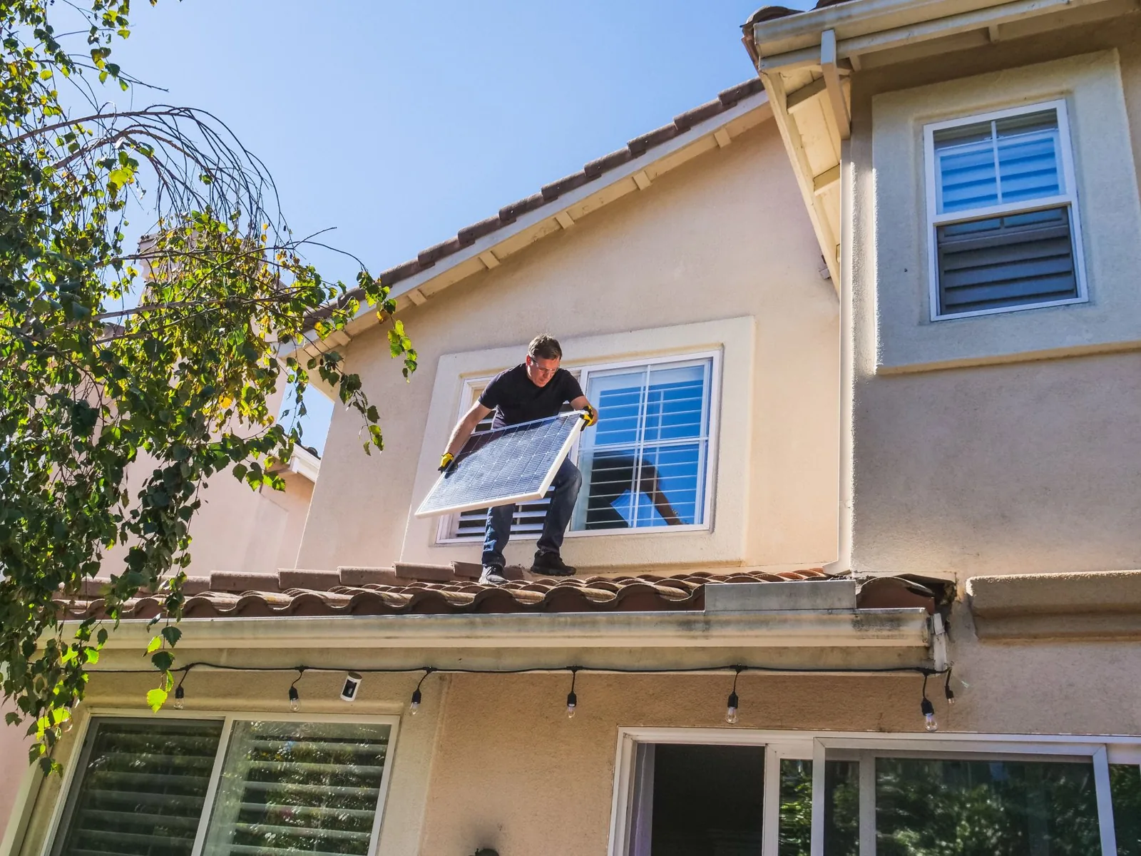 Vinyl replacement windows being lifted into place by a professional installer