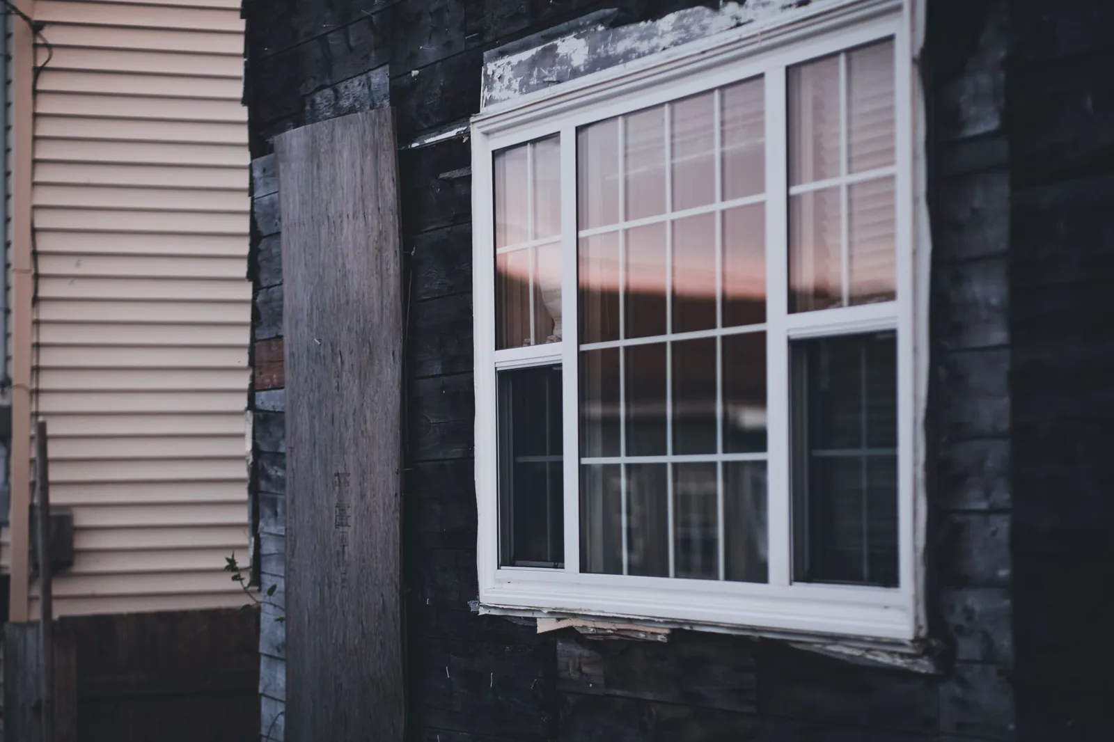 Installer measuring a new replacement window frame during installation